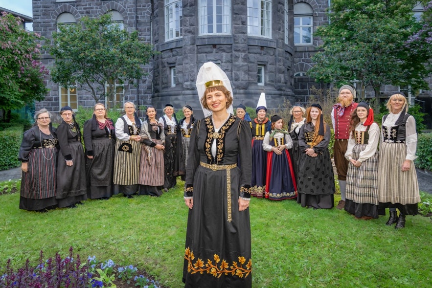 The fjallkona or lady of the mountain in Reykjavik in 2022, Sylwia Zajkowska, in front of the Althingi parlament building with people dressed in the icelandic national costume
