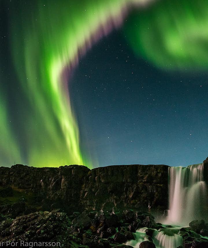 Northern Lights over a waterfall in Iceland