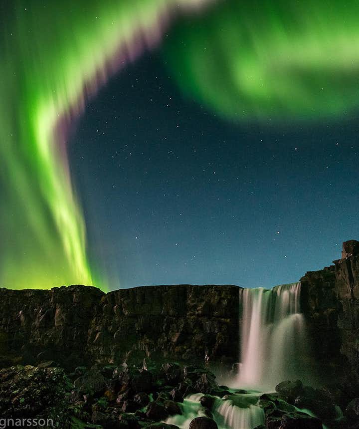 Northern Lights over a waterfall in Iceland