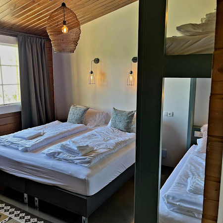 A family room with a double bed and bunk beds at Hotel Godafoss.