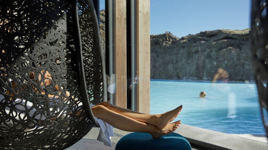 Woman relaxing in a hanging chair at the Retreat Spa at the Blue Lagoon in Iceland