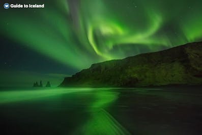 The northern lights shimmer over the South Coast of Iceland.