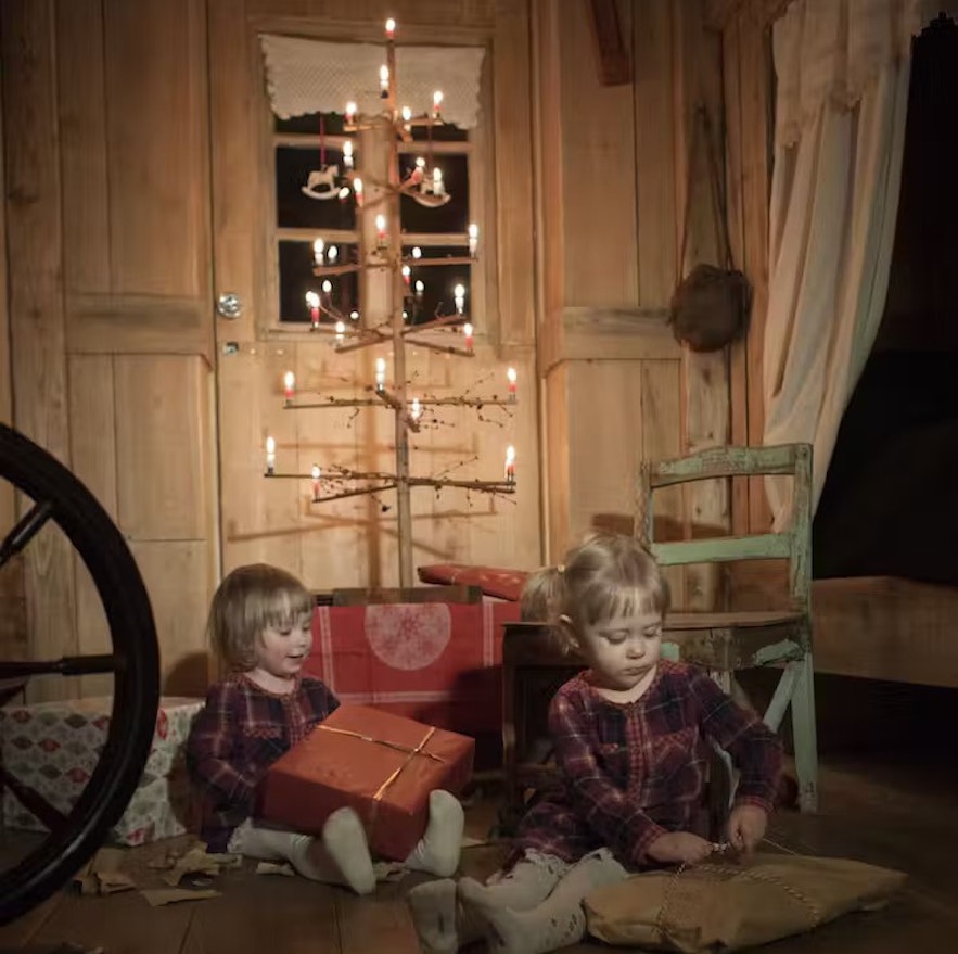 Two little girls participating in a historic Icelandic christmas