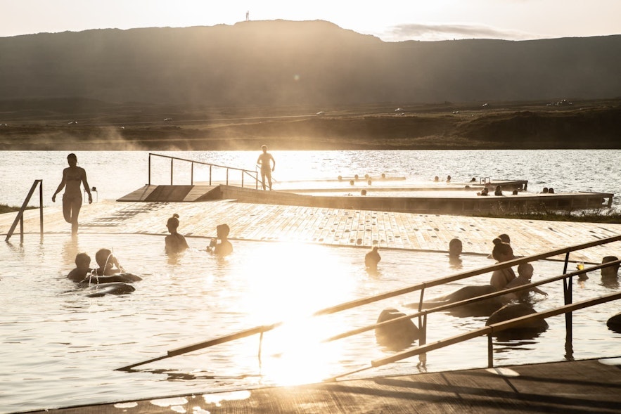 People enjoying the sunset at the Vok Baths in North Iceland