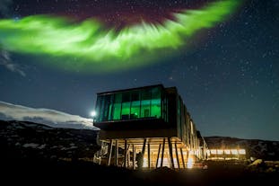 ION Adventure Hotel in Iceland under the colorful lights of the aurora borealis.