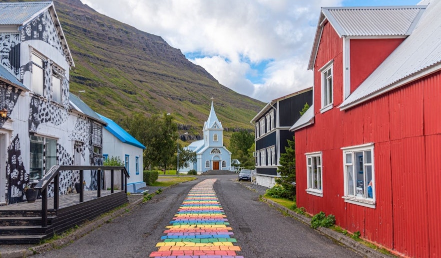 The rainbow street leading up to the Seydisfjordur church with colorfulhouses around