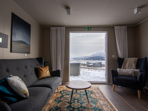 Embrace winter's charm from the warmth of your living room, where captivating views and cozy comfort converge at Viking Cottages