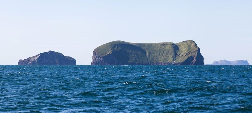 Vestmannaeyjar islands are characterized by their dramatic black cliffs rising from the ocean
