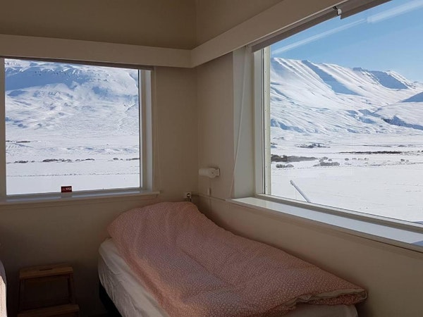 Incredible views of mountains and a snow-covered landscape from a room at Husabakki Guesthouse in North Iceland.