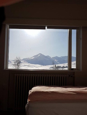 Breathtaking views of snowy mountains from a room at Husabakki Guesthouse in North Iceland.