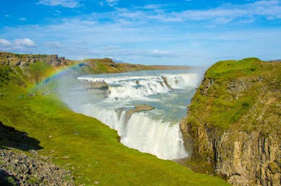 A rainbow shoots above the Gullfoss waterfall in the Golden Circle.