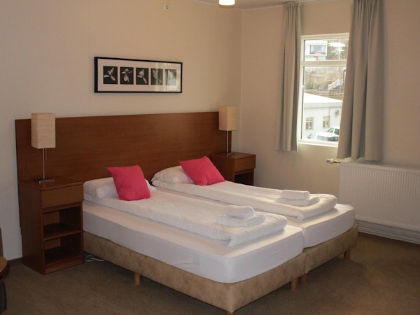 Your cozy bed awaits, promising a restful night's sleep in the heart of Welcome Apartments Olafsvik.