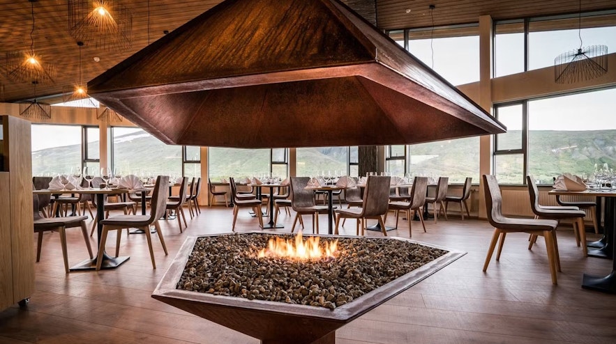 The restaurant of Hotel Husafell features beautiful views and coziness provided by a stunning fireplace