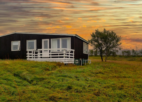 The sunset serves as a background for the Golden Circle Luxury Cottages.