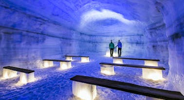 Travelers walk through the beautiful Langjokull glacier's tunnels.