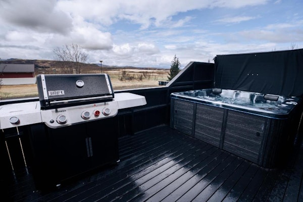 Guests can use the hot tub while relaxing outdoors.