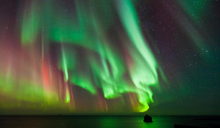 The northern lights over the sea in Iceland.