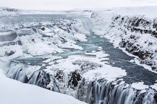 Gullfoss waterfall covered in snow and ice during winter in Iceland.