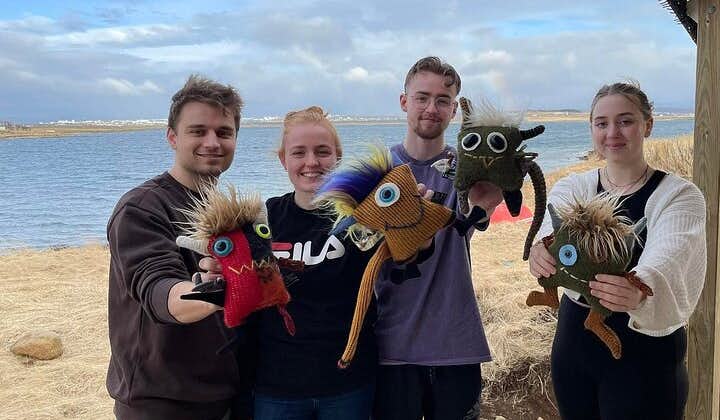 A group of friends posing with their Skrimsli toys in Iceland.