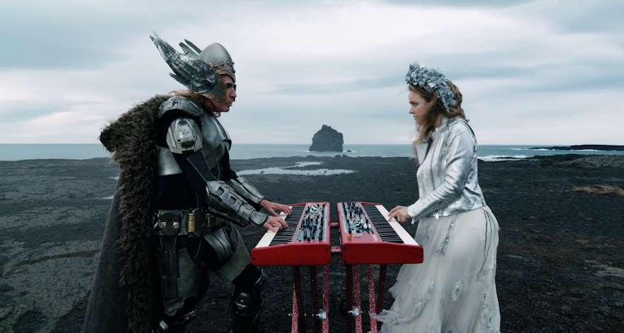 Will Ferrell and Rachel McAdams with the Karlin sea stack in the background, on the Reykjanes peninsula of Iceland