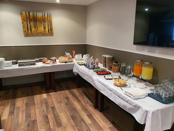 Savor a delightful continental breakfast at Café Cosy, just steps away from Studio 22.