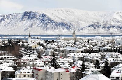 Snow covers Reykjavik and its surrounding landscapes.