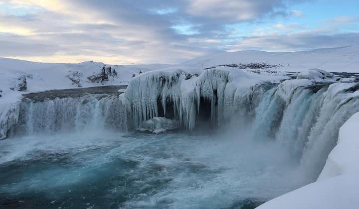 A frosty wonderland surrounds the majestic Godafoss during the winter months.