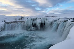 Experience the stark beauty of Godafoss during the tranquil winter months.