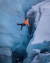 A person ziplines over a glacier moulin during a 7-hour private adventure tour.