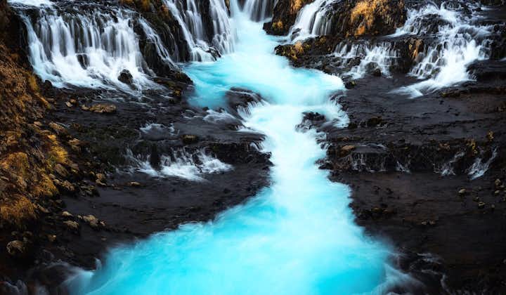 A waterfall with pale-blue waters in Iceland.