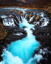 A waterfall with pale-blue waters in Iceland.