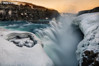 Gullfoss waterfall is surrounded by ice during winter.