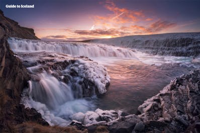 Gullfoss waterfall looks breathtaking with its icy and wide cascade in winter.