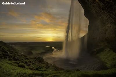 Seljalandsfoss waterfall on the South Coast boasts a beautiful water curtain.