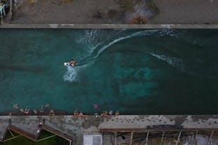 The Reykjaneslaug hot pool in the Westfjords is large enough for waterskiing activities.