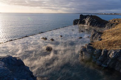 The Sky Lagoon geothermal spa's infinity pool overlooking the Atlantic Ocean.