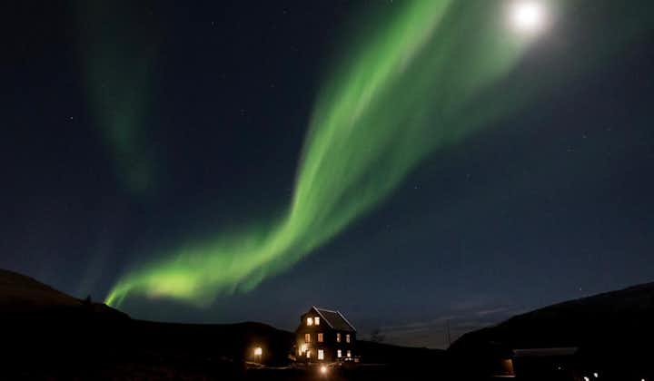The northern lights shine in the sky above the Hammsvik Nature Resort & Hot Springs.