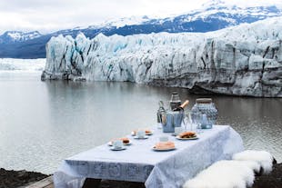 Indulge in luxury as you sip champagne, surrounded by the serene beauty of Fjallsarlon's icebergs.