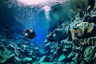 Two divers exploring the underwater beauty of Silfra fissure.