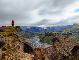 A hiker enjoying the breathtaking view of the Icelandic Highlands from Thorsmork.