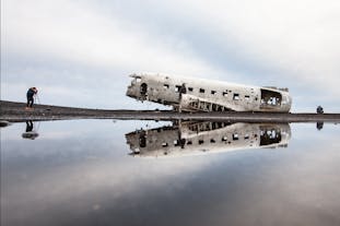 The haunting beauty of the DC-3 airplane wreck reflected on the tranquil waters of Solheimasandur, creating a mesmerizing mirror image.