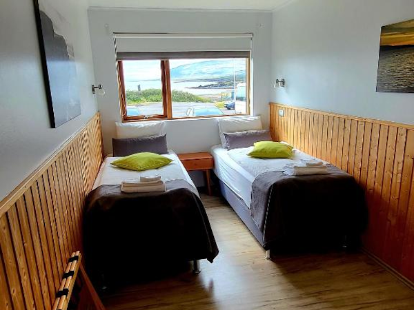 Enjoy the best of both worlds in the twin room at Hotel Flokalundur – a comfortable retreat and panoramic views.