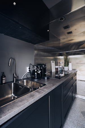 Fuel your day with ease in the compact kitchen at the Golden Circle Truck Hotel, featuring an electric kettle and coffeemaker fo