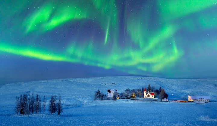 The northern lights swirl over Hvolsvollur, a town in South Iceland.