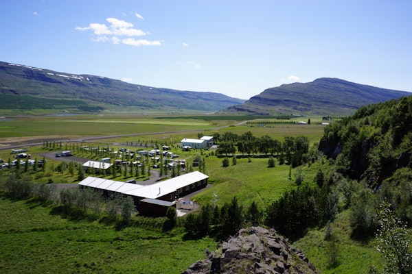 Fljotsdalsgrund framed by the majestic beauty of the Fljotsdalur valley, a harmonious blend of comfort and nature.