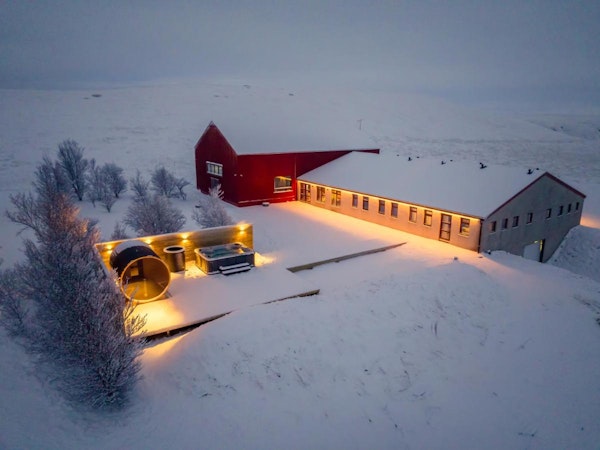 An overhead image of Deluxe Lodge amid the South Iceland countryside covered in a blanket of snow during winter.