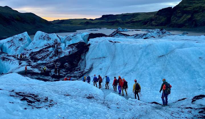 A group of adventurers hiking atop Solheimajokull glacier in Iceland.