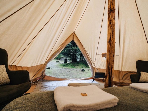 The view from the bed to the outside through the door of the glamping tent at the Golden Circle Tents Glamping Experience.