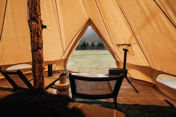 A chair in front of the doorway of one of the glamping tents at the Golden Circle Tents Glamping Experience.
