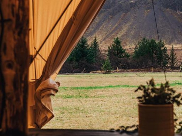 The view of the spectacular Icelandic scenery through the door of a glamping tent at the Golden Circle Tents Glamping Experience